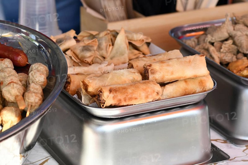 Tray of fried Asian springrolls and wontons at street food market