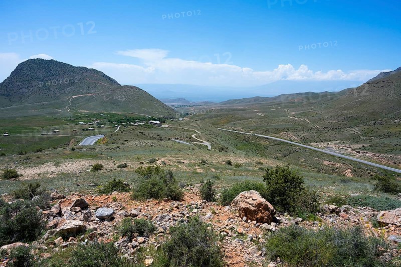 Wide landscape with hills and a winding road under a blue sky, view from the Tukh Manuk Pass to the border triangle of Armenia, Turkey and the Azerbaijani enclave of Nakhchivan, Nakhichevan, Iran can be seen behind Turkey, M2, Armenia