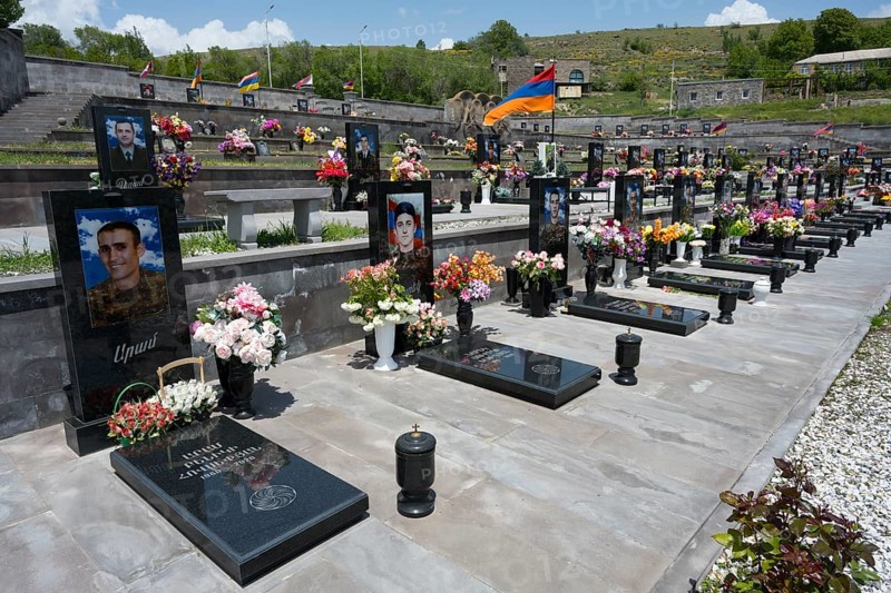Graves in rows with portraits and flowers, Armenian flag in the background, graves of 2020, victims of the war between Armenia and Azerbaijan, cemetery, Sisian, Sissian, Sjunik province, historical Sangesur, Armenia