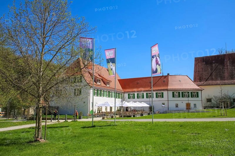 Gestütsgasthof near the stud farm and the Lauterquelle, terrace, sunshades, catering, restaurant, building, green shutters, flags, flagpole, Offenhausen, municipality of Gomadingen, Swabian Alb, Baden-Württemberg, Germany