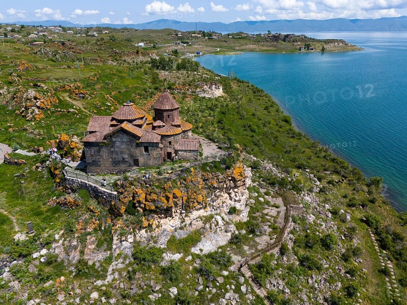 Church perched above a magnificent lake with a panoramic view of the surrounding countryside, aerial view, Hajrawank Monastery, Hayravank, Lake Sevan, Gegharkunik Province, Armenia
