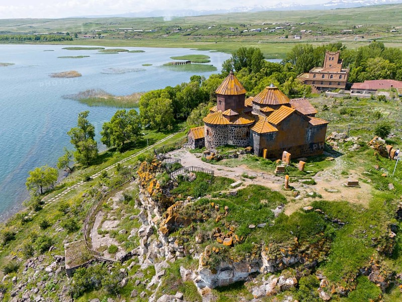Historic church on a cliff with a surrounding green landscape and a lake, aerial view, Hajrawank Monastery, Hayravank, Lake Sevan, Gegharkunik Province, Armenia
