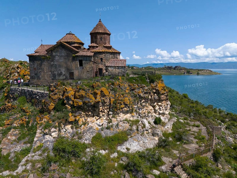 Historic church on a hill overlooking a lake under a bright blue sky, aerial view, Hajrawank Monastery, Hayravank, Lake Sevan, Gegharkunik Province, Armenia