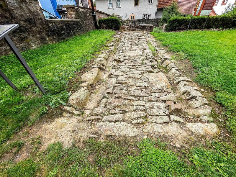 Archaeological find of original small section with old stones from historic trade route between Frankfurt am Main and Leipzig, Steinau an der Straße, Hesse, Germany, relocated to secure protected site in Steinau an der Straße