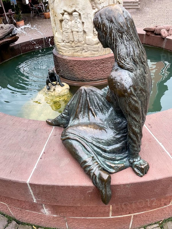 Sculptures figures of princess and frog holding golden ball representation from fairy tale the frog king by Brothers Grimm at in fairy tale fountain in Steinau an der Straße, Steinau an der Straße, Hesse, Germany