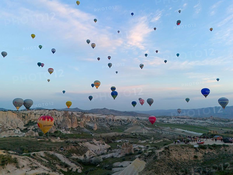 Many colourful hot air balloons float over a vast Turkish landscape in the early morning, aerial view, Göreme National Park, Göreme Tarihî Millî Parki, Nevsehir Province, Nevsehir, Cappadocia, Cappadocia, Kapadokya, Cappadocia, Central Anatolia, Turkey