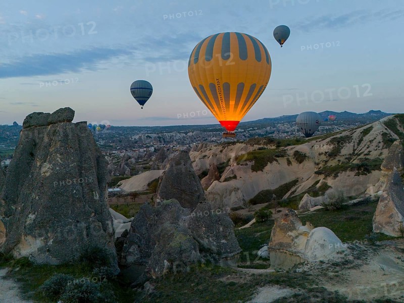 Hot air balloons hovering over a rocky landscape at dawn in Cappadocia, aerial view, Göreme National Park, Göreme Tarihî Millî Parki, Nevsehir Province, Nevsehir, Cappadocia, Cappadocia, Kapadokya, Cappadocia, Central Anatolia, Turkey