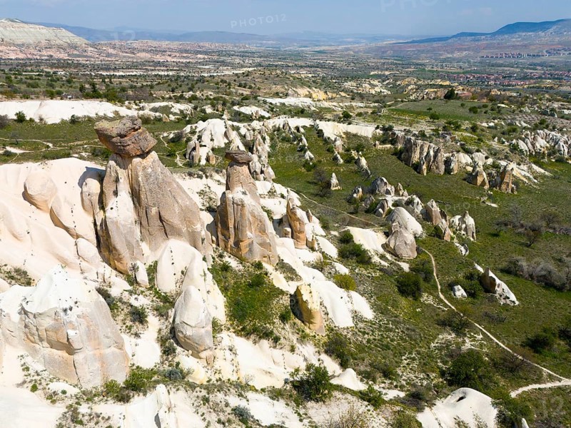 Rock formations and green areas in a hilly landscape with a wide view, aerial view, fairy chimneys near Ürgüp, Göreme National Park, Göreme Tarihî Millî Parki, Nevsehir Province, Nevsehir, Cappadocia, Cappadocia, Kapadokya, Cappadocia, Central Anatolia, Turkey