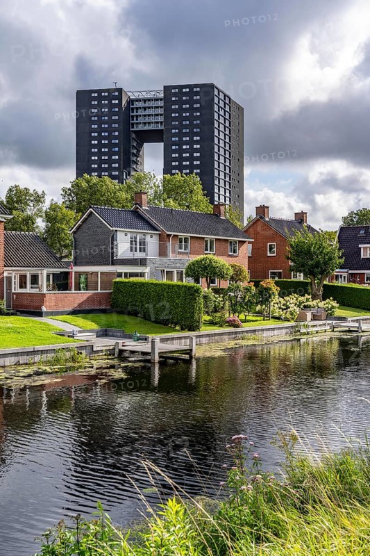Tasmantoren residential tower block in the Oosterhogebrug district in the city of Groningen, 75 metres high with 218 flats on 23 floors, residential buildings on Rijksweg on the Damsterdiep canal, Netherlands