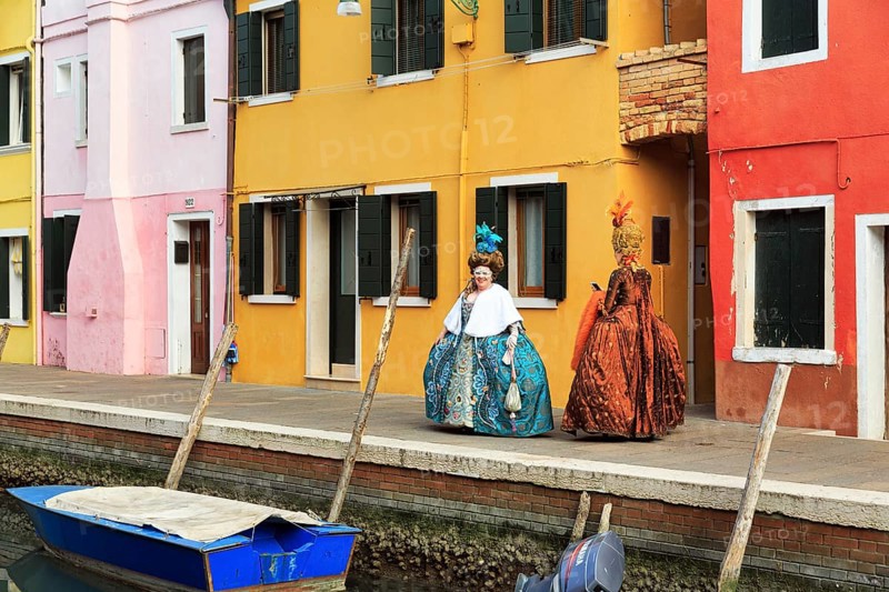 Two dressed up woman, Venetian costumes with masks, colourful facades, Burano, Venice, Veneto, Italy