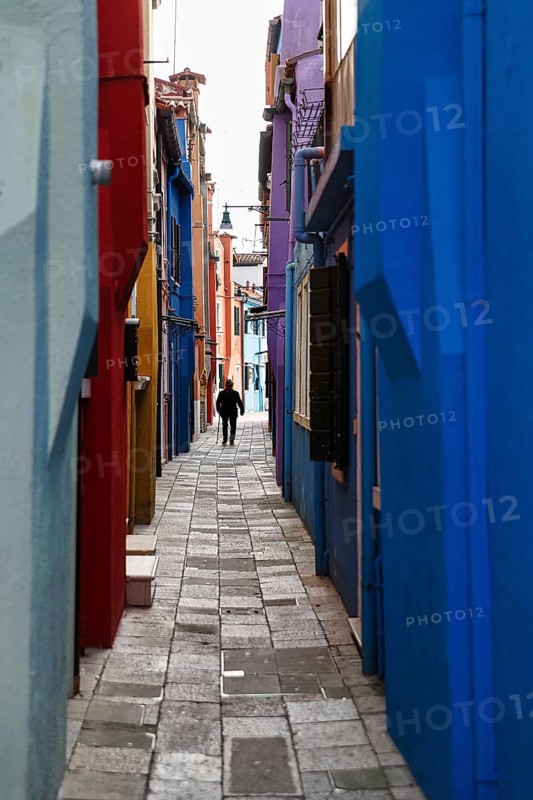 Strollers in winter, anonymous old man in a narrow alley, colourful facades, Burano, Venice, Veneto, Italy
