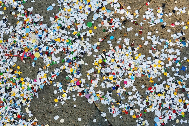 Confetti on asphalt, full-size, symbolic image, waste, environmental pollution, Carnival in Venice, Italy