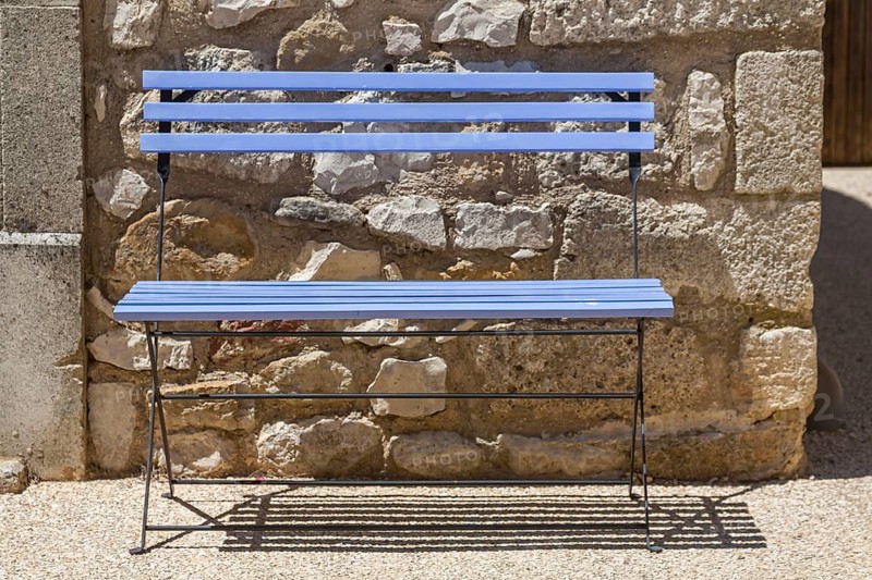 Blue bench in front of a house facade, Provence, France