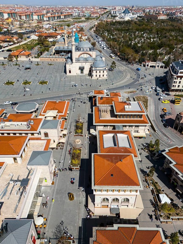 Bird's eye view of an urban landscape with red roofs and a mosque in the background in sunny weather, aerial view, pedestrian zone, Mevlânâ Museum, Mevlana, landmark, Mausoleum of Mevlânâ Dschalal ad-Din Rumi, Konya Sultan Selim Camii, Konya, Central Anatolia, Turkey