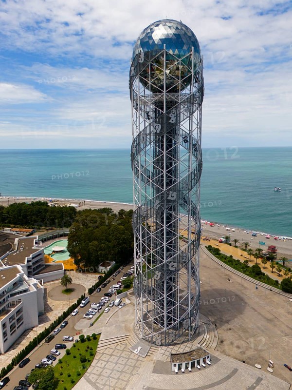 Modern tower by the sea with a view of the coast and the beach under a blue sky, aerial view, Alphabetic Tower, Tower of the Georgian Alphabet, Miracle Park, Batumi, Black Sea, Adjara region, Adjara, Autonomous Republic, Georgia