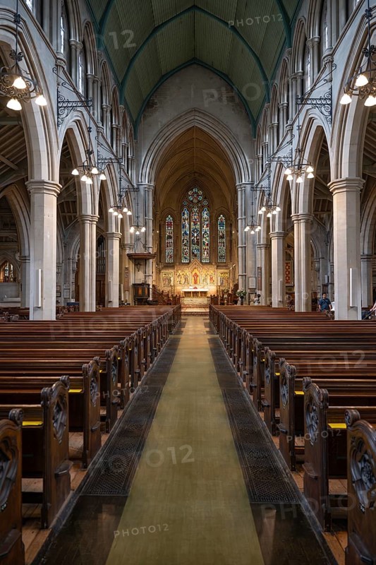 Neo-Gothic church interior with high arches and wooden benches, St Mary Abbot Church, Kensington, London, England, Great Britain
