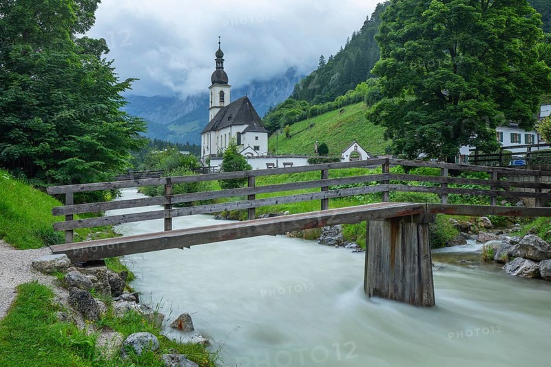 St Sebastian in Ramsau in Berchtesgadener Land with rain clouds after heavy rain