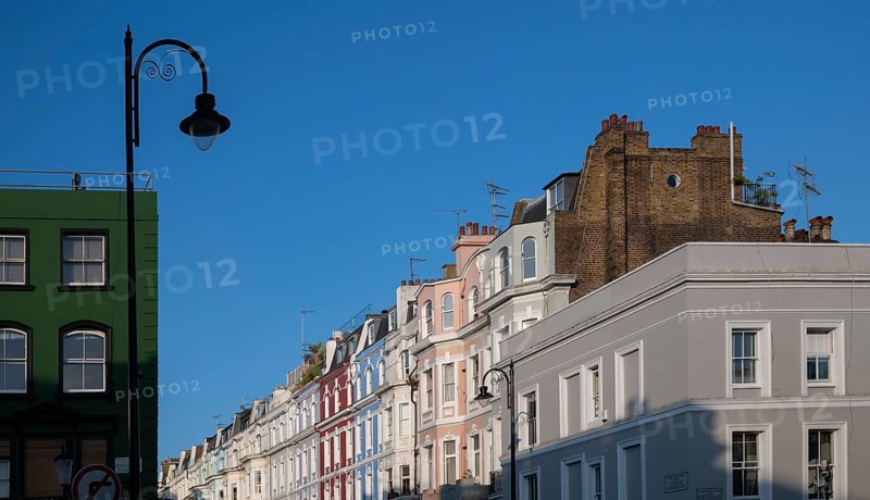 Terraced houses, townhouses with different, colourfully painted facades under a blue sky, Portobello Road, Notting Hill, London, England, Great Britain