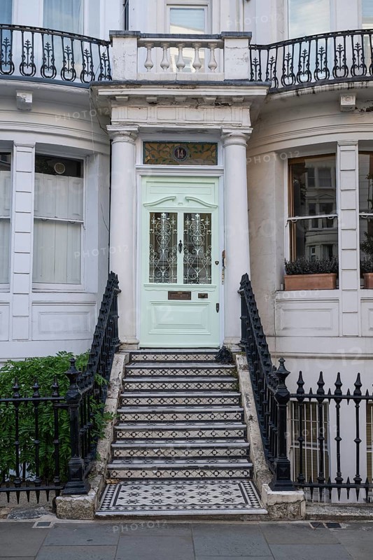 House entrance with mint green door, black and white staircase and decorative wrought iron railings, Ladbroke Grove, Notting Hill, London, England, Great Britain