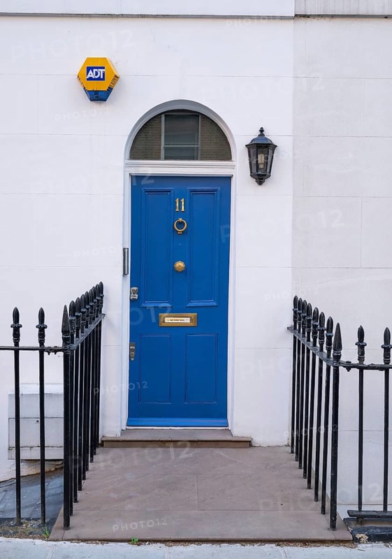 Blue door with house number 11 flanked by a lantern and a security sign, surrounded by a wrought iron fence, Kensington, London, England, United Kingdom