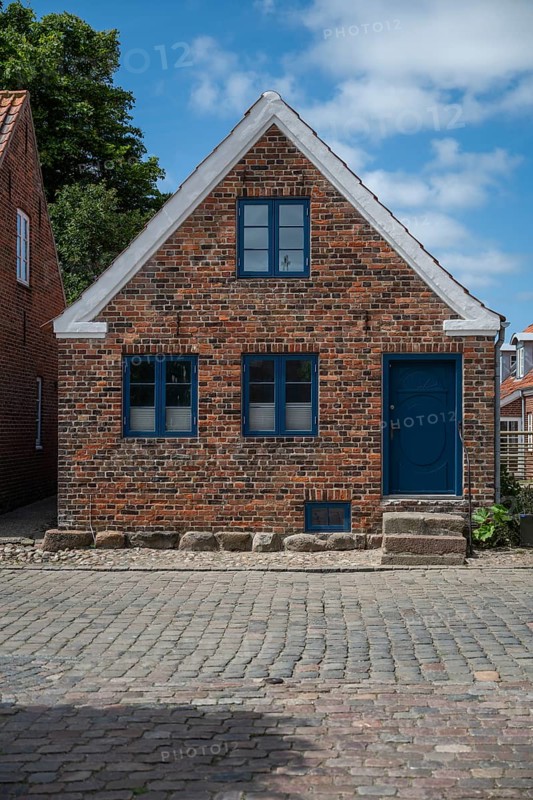 A traditional brick house with a blue door and blue windows, Old Town, Ringkøbing, Ringkøbing Fjord, Denmark
