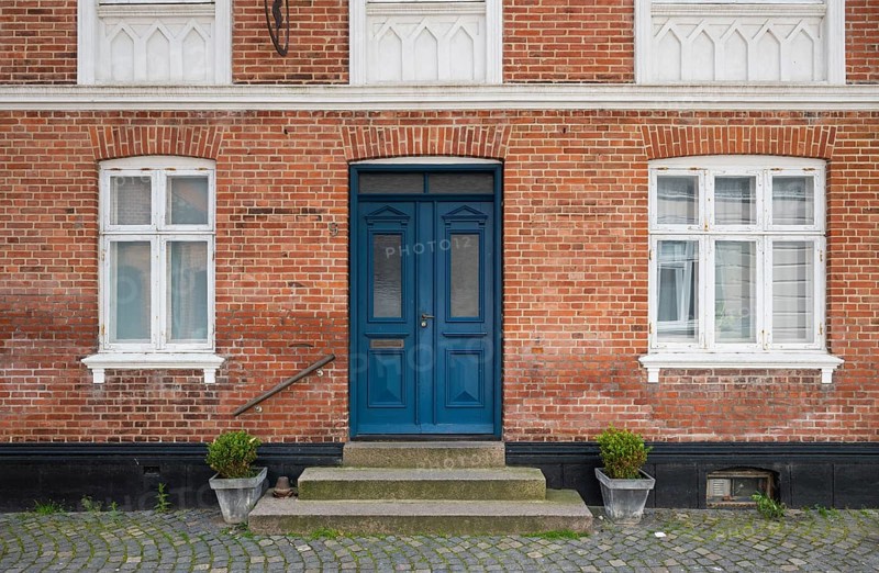 Brick façade with a striking blue door and potted plants, Old Town, Ringkøbing, Ringkøbing Fjord, Denmark