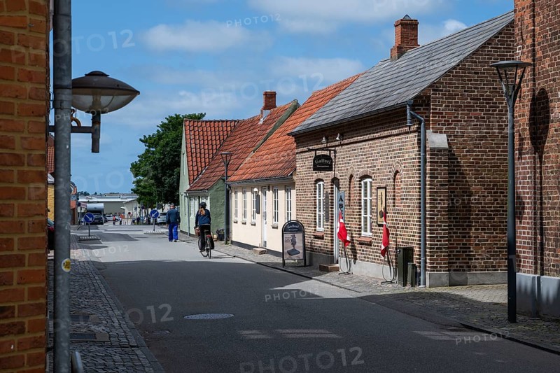 Street with historic brick houses and cyclists, Old Town, Ringkøbing, Ringkøbing Fjord, Denmark