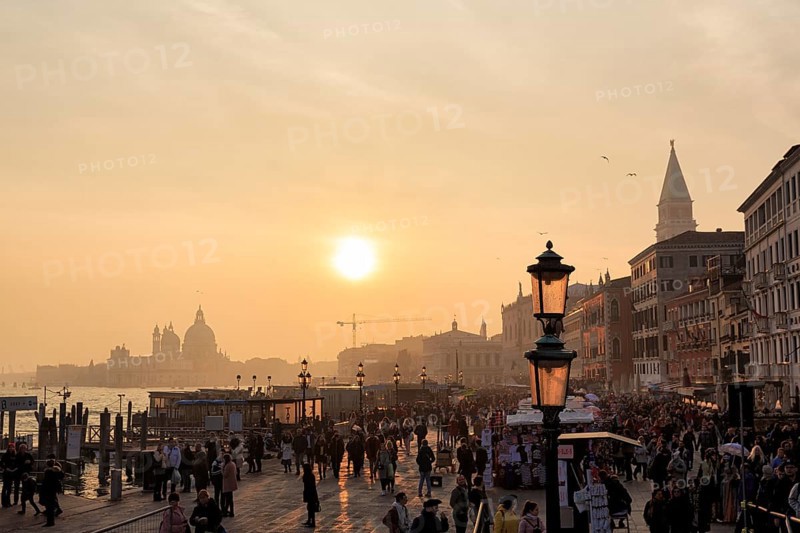 Crowd, Boat dock at St Mark's Square, St Mark's Basilica, Church on the horizon, Sunset in winter, Backlight, Venice, Italy
