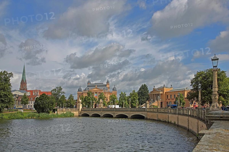 View over the castle lake to the castle bridge with tower of the cathedral, state theatre and state museum, waterfront promenade, cityscape, Schwerin, Mecklenburg-Western Pomerania, Germany