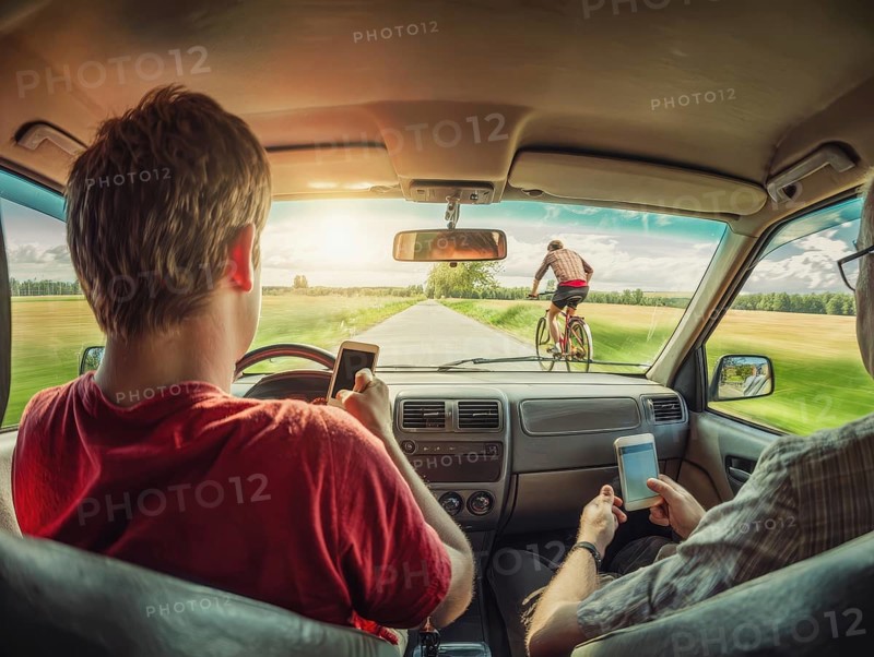 A car driver and his passenger look at their smartphones while driving and endanger themselves and the cyclist in front. Carelessness, recklessness, distraction in road traffic, accident risk, AI generated, AI generated