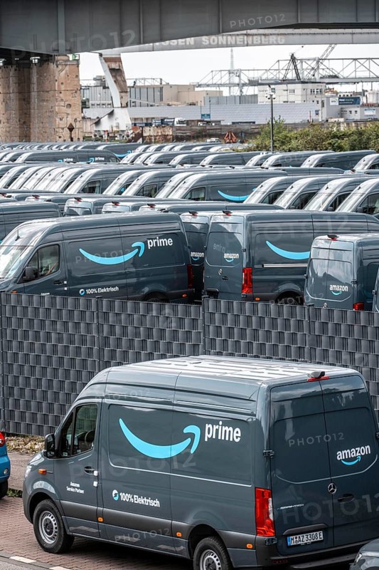 New delivery vehicles for the online mail order company Amazon Prime, with electric drive, are waiting for delivery in the inland port of Duisburg, Duisport, North Rhine-Westphalia, Germany