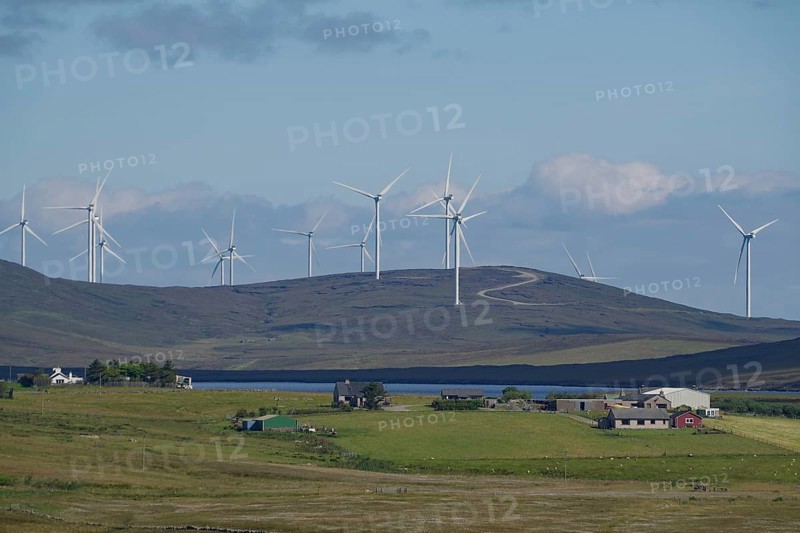 Wind farm on green hills under blue sky with clouds, rural environment, Shetland Islands, Scotland, United Kingdom
