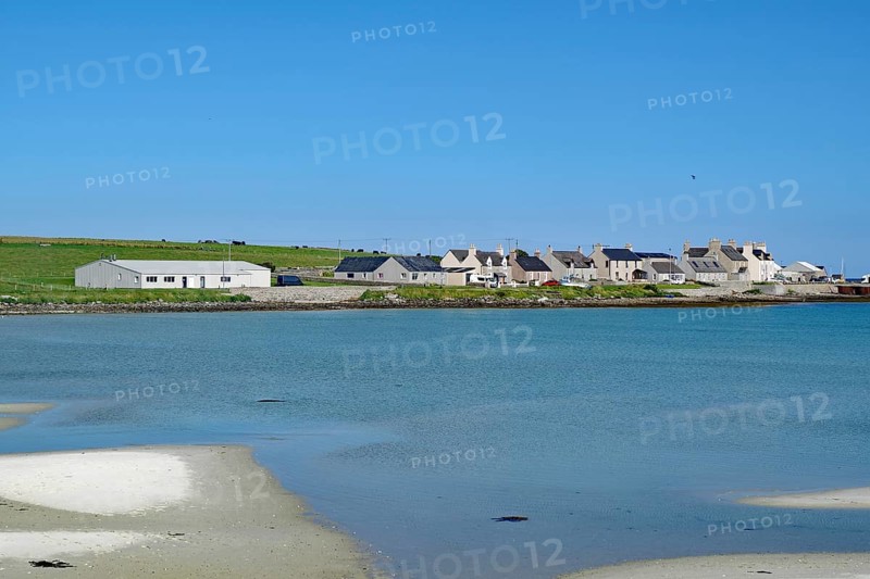 Small coastal village with houses on the waterfront under a blue sky, Pierowal, Westray, Orkney Islands, Scotland, Great Britain