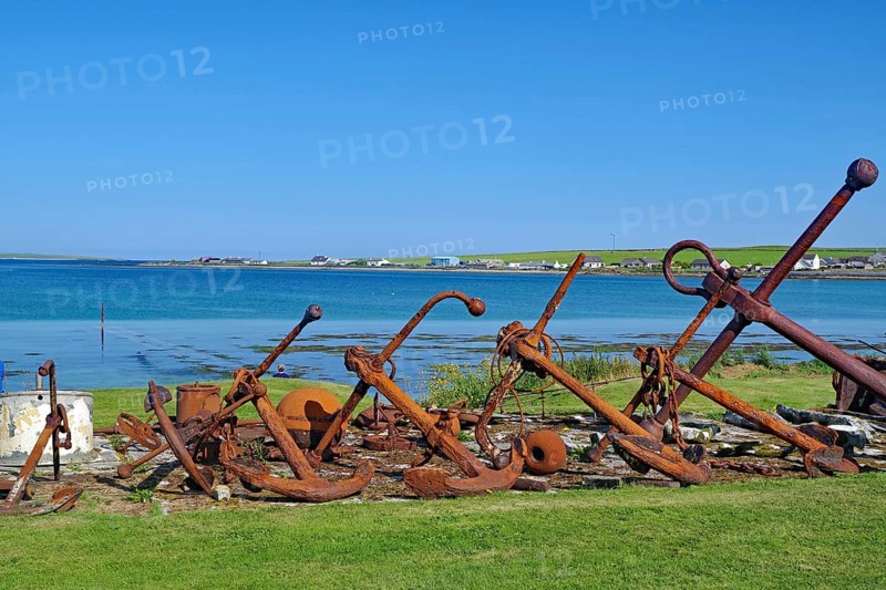 Rusty anchors in a meadow on the coast with sea in the background, Pierowal, Westray, Orkney Islands, Scotland, Great Britain