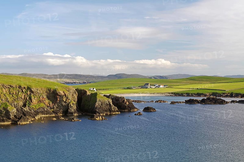 Coastal landscape with cliffs and green land under a slightly cloudy sky, Hillswick, Eshaness, Shetland Islands, Scotland, United Kingdom