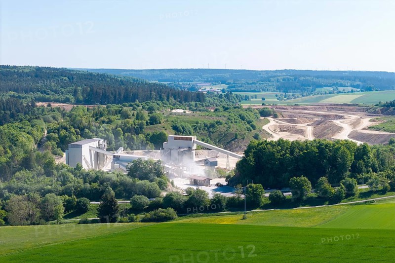 A large industrial plant embedded in a hilly, green landscape, gravel works near Böhmenkirch, Swabian Alb, Baden-Württemberg, Germany