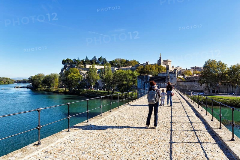Strollers on the Pont Saint Benezet, Pont d'Avignon, Avignon Cathedral, Avignon, Vaucluse, France