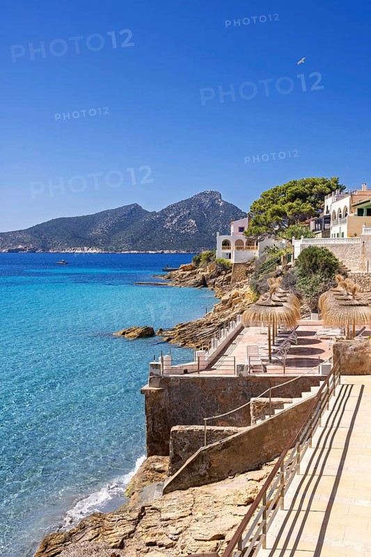 House on the seashore of the blue Mediterranean Sea on a sunny summer day, Sant elm, Mallorca, Spain