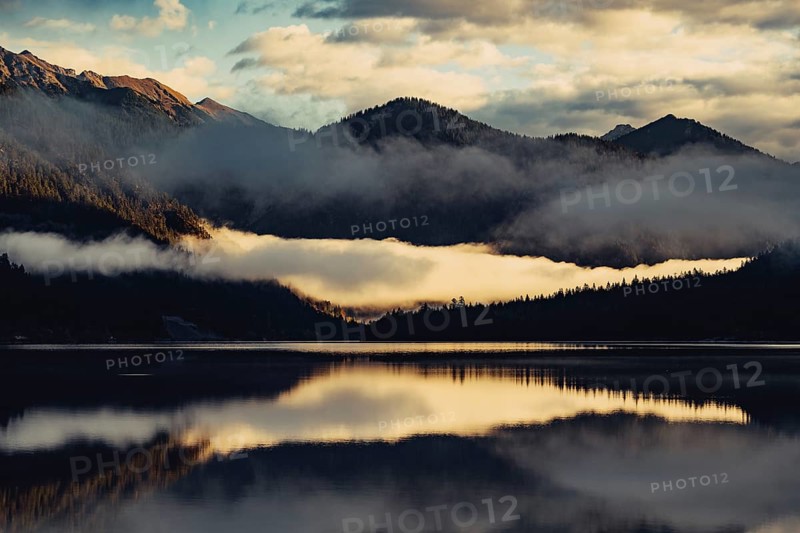 Sunrise with reflections and alpenglow in Lake Heiterwanger See in Tyrol in the Alps in Austria