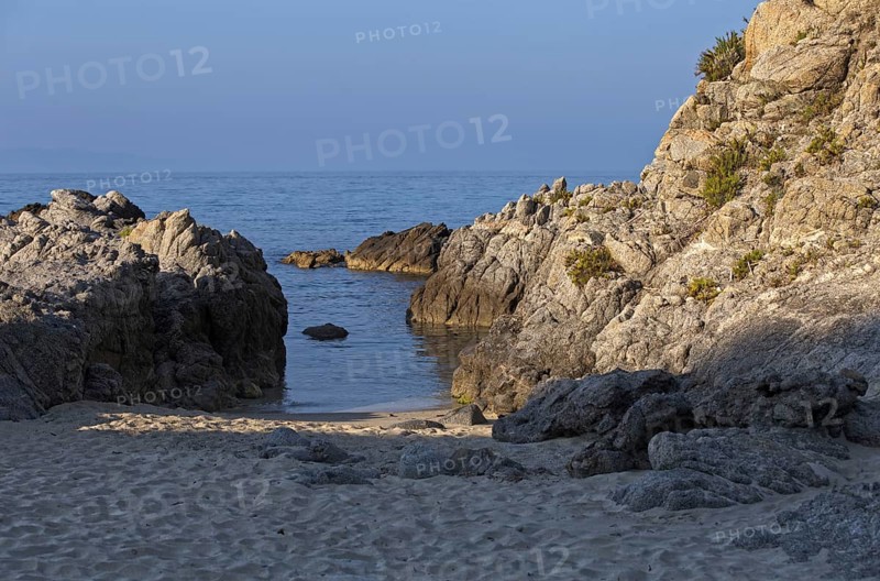 Small bay with calm water, surrounded by rocks and sandy beach, Ricadi, Capo Vaticano