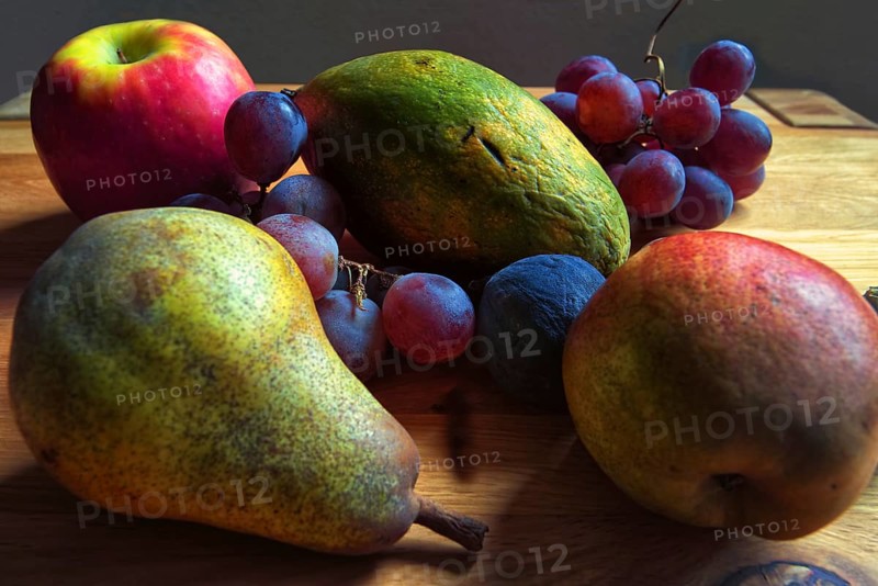 Colourful composition of pears, grapes and apples on a wooden table, Willich, North Rhine-Westphalia