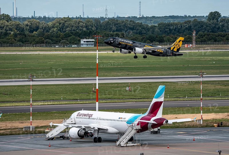 Düsseldorf Airport, Eurowings aircraft taking off, Eurowings Airbus on the apron, BVB Borussia Dormtund branding, team bus, North Rhine-Westphalia, Germany