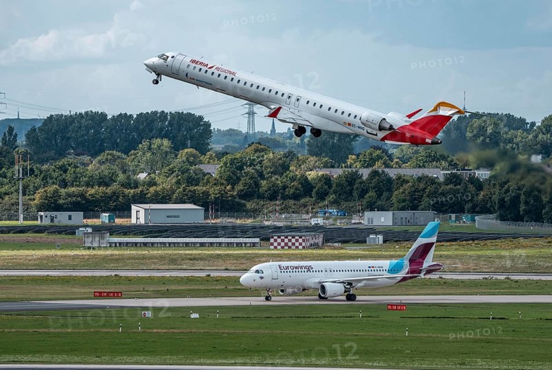 Düsseldorf Airport, Iberia Regional Mitsubishi CRJ-1000, Air Nostrum, on take-off, Eurowings Airbus aircraft after landing, North Rhine-Westphalia, Germany