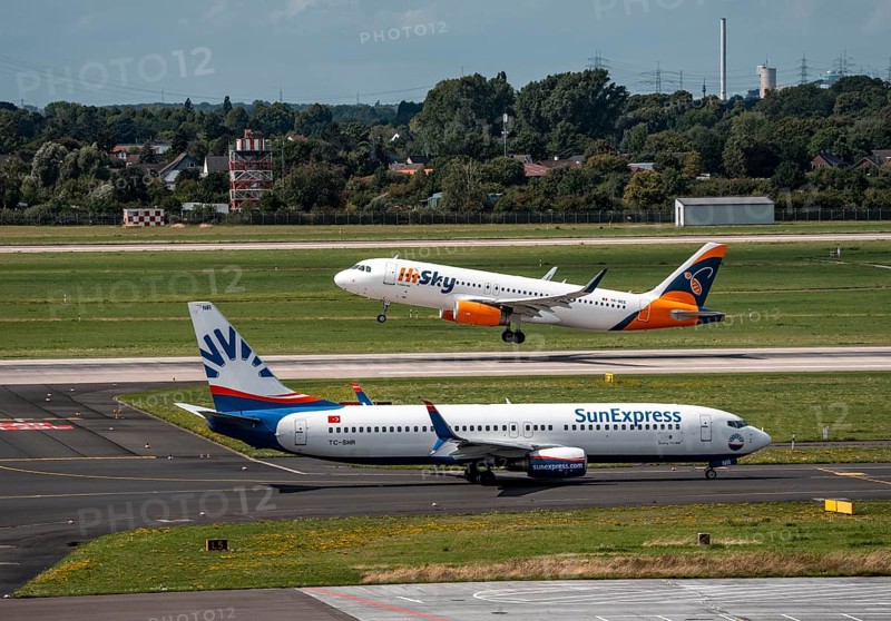 Düsseldorf Airport, Sunexpress Boeing 737 aircraft on the apron, HiSky Europe Airbus A320-200 taking off, North Rhine-Westphalia, Germany