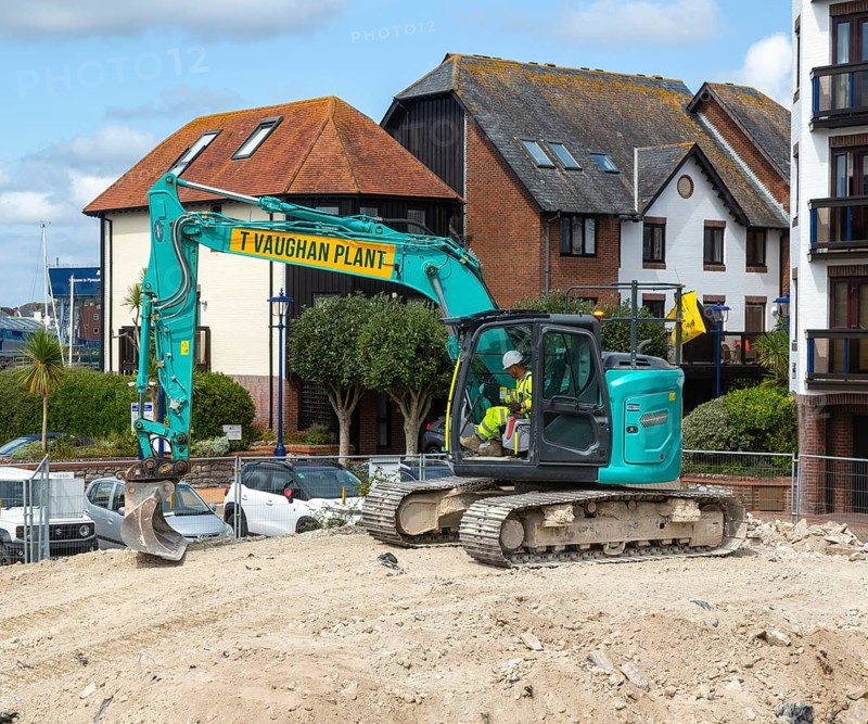 Kobelco long reach crawler tracked excavator vehicle on construction site, Millbank marina village, Plymouth, Devon, England, UK