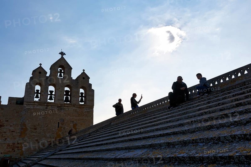 Viewing terrace of the church Notre-Dame-de-la-Mer, tourists on the roof of the fortified church, backlight, Saintes-Maries-de-la-Mer, Camargue, France