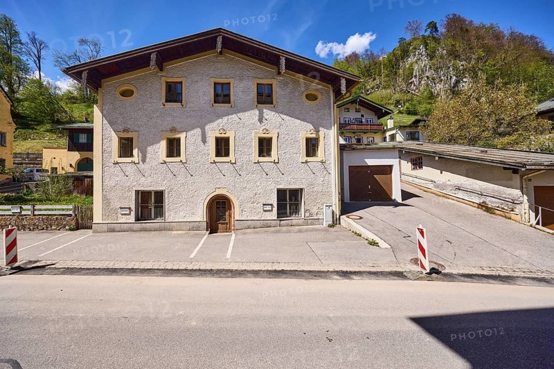 Historic building, garage, facade, window, door, mountain landscape, hill, forest, barrier beacons, blue sky, cumulus clouds, cirrostratus clouds, town hall square, Berchtesgaden, Upper Bavaria, district Berchtesgadener Land, Bavaria, Germany