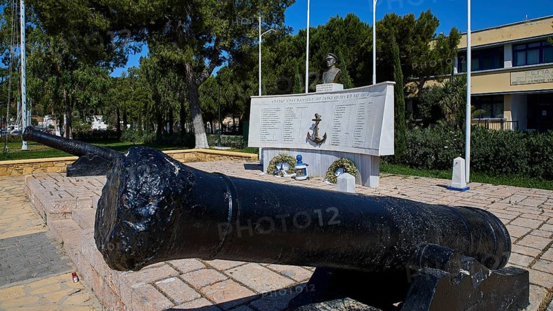 A monument with cannons and bust, surrounded by inscriptions and green vegetation in the open, photos related to WW2, Battle of Leros, Portolago, Lakki, Leros, Dodecanese, Greek Islands, Greece