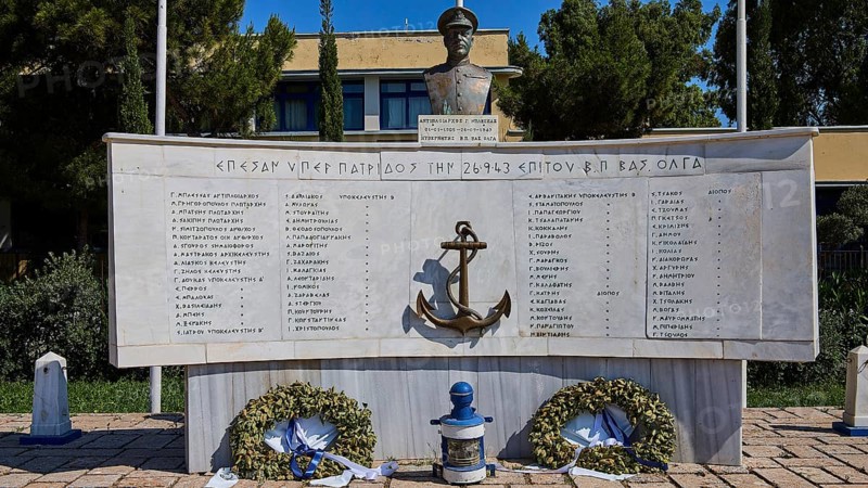 A monument with bust and anchor in the centre, surrounded by plaques with inscriptions and wreaths, photos relating to WW2, Battle of Leros, Portolago, Lakki, Leros, Dodecanese, Greek Islands, Greece