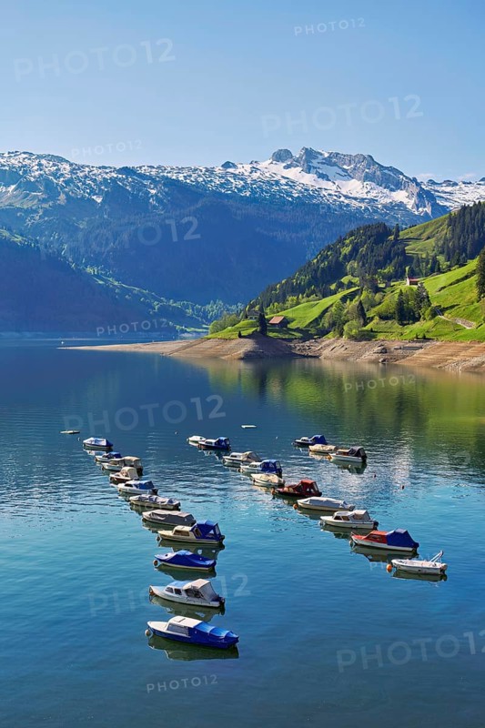 Motorboats moored at the reservoir, snow-covered Alps in the background, Lake Wägital, Canton Schwyz, Switzerland